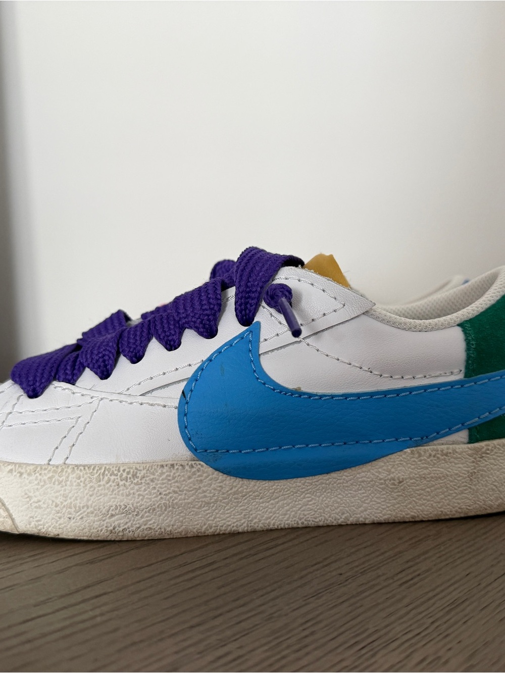 White Sneakers with Blue Swoosh and Purple Laces